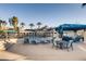 A community pool with chairs, tables, and covered seating areas for residents to enjoy at 10001 Peace Way # 2335, Las Vegas, NV 89147