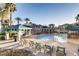 Community pool area featuring lounge chairs, covered seating, and well-maintained landscaping at 10001 Peace Way # 2335, Las Vegas, NV 89147