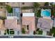 Bird's-eye view of the property, displaying the house, backyard with covered patio, pool, and surrounding neighborhood at 1027 Dawn Valley Dr, North Las Vegas, NV 89031