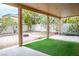 View of the backyard from the covered patio, showcasing the gravel landscape and small patch of artificial grass at 1027 Dawn Valley Dr, North Las Vegas, NV 89031