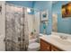 Stylish bathroom with a charming ship-themed shower curtain and custom wall art at 1027 Dawn Valley Dr, North Las Vegas, NV 89031