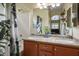 Bathroom featuring dual sinks, granite countertops, and a shower-tub combo at 1027 Dawn Valley Dr, North Las Vegas, NV 89031