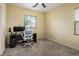 Home office with a desk, rolling chair, and ample natural light at 1027 Dawn Valley Dr, North Las Vegas, NV 89031