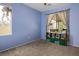Comfortable bedroom with neutral carpet, a large window, and decorative shelving at 1027 Dawn Valley Dr, North Las Vegas, NV 89031