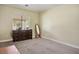 Spacious bedroom with a dresser and a free standing mirror by a large window at 1027 Dawn Valley Dr, North Las Vegas, NV 89031