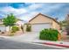 Street view of a single-Gathering home, highlighting the attached garage and low-maintenance landscaping at 1027 Dawn Valley Dr, North Las Vegas, NV 89031