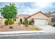 The home features desert landscaping, a tile roof, and an attached garage, providing curb appeal and practicality at 1027 Dawn Valley Dr, North Las Vegas, NV 89031