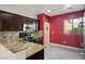 Stylish kitchen featuring dark wood cabinets, granite countertops, and stainless steel appliances for modern convenience at 1027 Dawn Valley Dr, North Las Vegas, NV 89031