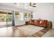 Spacious living room with wood-style flooring, large windows, and access to the backyard, perfect for entertaining at 1027 Dawn Valley Dr, North Las Vegas, NV 89031