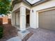 Charming covered entryway with stone accents, leading to the front door and attached two-car garage at 1030 Maple Pines Ave, North Las Vegas, NV 89081