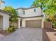 Inviting two-story home boasts a pristine exterior, lush landscaping, and a spacious two-car garage at 1030 Maple Pines Ave, North Las Vegas, NV 89081