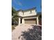 A charming two-story home with a two car garage and a brick driveway at 1030 Maple Pines Ave, North Las Vegas, NV 89081