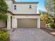 Welcoming front exterior of a two-story house featuring an attached two-car garage and beautiful landscaping at 1030 Maple Pines Ave, North Las Vegas, NV 89081