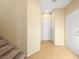 Hallway with tan walls and tile floors leads to the garage and front door at 1030 Maple Pines Ave, North Las Vegas, NV 89081