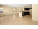Spacious, open-concept kitchen area with granite counters, dark cabinets, and tile flooring at 1030 Maple Pines Ave, North Las Vegas, NV 89081