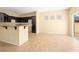 Open-concept kitchen featuring granite countertops, black cabinetry, and tile flooring at 1030 Maple Pines Ave, North Las Vegas, NV 89081