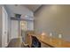 Hallway featuring a built-in desk area, neutral paint, and access to the bathroom and bedrooms at 10456 Processor Ct, Las Vegas, NV 89129