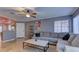 Inviting living room boasts tile floors, ceiling fan, and neutral paint, creating a cozy atmosphere at 10456 Processor Ct, Las Vegas, NV 89129