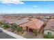 Low aerial view of a single-story home with desert landscaping in a neighborhood with mountain views at 10943 Artisan Ranch Ave, Las Vegas, NV 89166