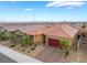 Aerial view of a single-story home with desert landscaping in a vibrant neighborhood with mountain views at 10943 Artisan Ranch Ave, Las Vegas, NV 89166