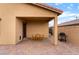 Covered patio features table and chairs, and a barbeque at 10943 Artisan Ranch Ave, Las Vegas, NV 89166