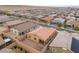 Aerial view of the backyard featuring a patio, desert landscaping, and a block wall fence at 10943 Artisan Ranch Ave, Las Vegas, NV 89166