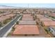 Aerial view of the backyard featuring a patio, desert landscaping, and a block wall fence at 10943 Artisan Ranch Ave, Las Vegas, NV 89166