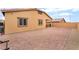 Brick-paved backyard with covered patio, furniture, and grill at 10943 Artisan Ranch Ave, Las Vegas, NV 89166