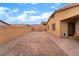 Spacious brick-paved backyard with block wall and string lights at 10943 Artisan Ranch Ave, Las Vegas, NV 89166