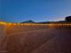 Large backyard featuring a spacious brick patio and string lights providing a warm and inviting ambiance at 10943 Artisan Ranch Ave, Las Vegas, NV 89166