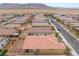 Aerial view of the backyard with desert landscaping and block wall fencing. Mountains in the distance at 10943 Artisan Ranch Ave, Las Vegas, NV 89166