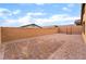 Large brick-paved backyard with block wall and string lights at 10943 Artisan Ranch Ave, Las Vegas, NV 89166