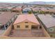 Aerial view of the backyard featuring a covered patio, desert landscaping, and a block wall fence at 10943 Artisan Ranch Ave, Las Vegas, NV 89166