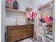 Walk-in closet with changing table, dresser, and hanging clothes at 10943 Artisan Ranch Ave, Las Vegas, NV 89166