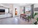 Bright dining area featuring a table with seating for four, connected to the living space and backyard patio at 10943 Artisan Ranch Ave, Las Vegas, NV 89166