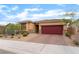 Single story home featuring a red tile roof, a brick driveway, and desert landscaping in the front yard at 10943 Artisan Ranch Ave, Las Vegas, NV 89166