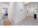 Bright hallway with tile flooring, white walls, and natural light streaming through the front door's glass panes at 10943 Artisan Ranch Ave, Las Vegas, NV 89166