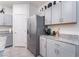Kitchen area featuring stainless steel refrigerator and gray cabinets with granite countertops and modern fixtures at 10943 Artisan Ranch Ave, Las Vegas, NV 89166