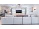 Bright open-concept living space boasts a large sectional sofa, ceiling fan, and stylish moon decor at 10943 Artisan Ranch Ave, Las Vegas, NV 89166