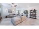 Comfortable living room with an oversized sectional sofa, ceiling fan, stylish decor and tile floors at 10943 Artisan Ranch Ave, Las Vegas, NV 89166