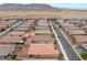 Aerial view of a well-maintained neighborhood, displaying neat rows of houses and desert landscaping at 10943 Artisan Ranch Ave, Las Vegas, NV 89166