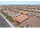 A scenic view showcases a well-planned community with uniform rooftops and manicured landscaping at 10943 Artisan Ranch Ave, Las Vegas, NV 89166