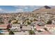 Panoramic aerial view highlighting a suburban neighborhood with well-kept homes, mountain views, and convenient city access at 1117 Azure Heights Pl, Las Vegas, NV 89110