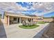 The home offers an extended covered patio, lush lawn, mountain views and desert landscaping at 1117 Azure Heights Pl, Las Vegas, NV 89110