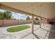 Cozy covered patio with stone pillars overlooking a lush lawn and landscape, offering a relaxing outdoor living space at 1117 Azure Heights Pl, Las Vegas, NV 89110