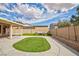 A spacious backyard featuring a plush lawn, charming string lights, and a cozy covered patio perfect for outdoor relaxation at 1117 Azure Heights Pl, Las Vegas, NV 89110