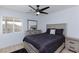 This bedroom features a ceiling fan, a window, and a light wood dresser with a mirror at 1117 Azure Heights Pl, Las Vegas, NV 89110