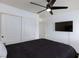 The bedroom features a ceiling fan, large closets and a wall-mounted TV at 1117 Azure Heights Pl, Las Vegas, NV 89110