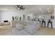 Spacious living room featuring a large sectional sofa, ceiling fan, and light wood floors at 1117 Azure Heights Pl, Las Vegas, NV 89110