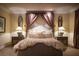 Spacious primary bedroom featuring luxurious linens, decorative pillows, and custom bedside lamps at 1413 Iron Hills Ln, Las Vegas, NV 89134